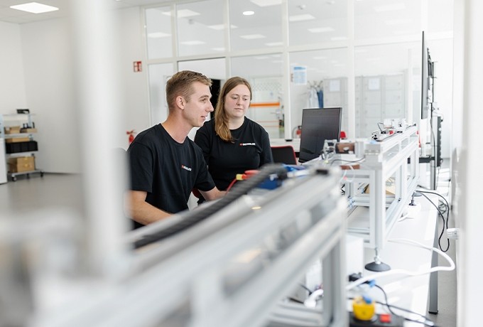 two oechsler employees working on testing applications