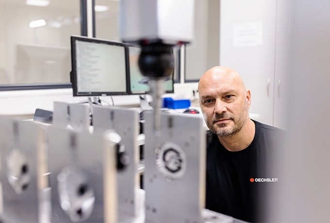 powder injection molding testing process with engineer in front of testing station